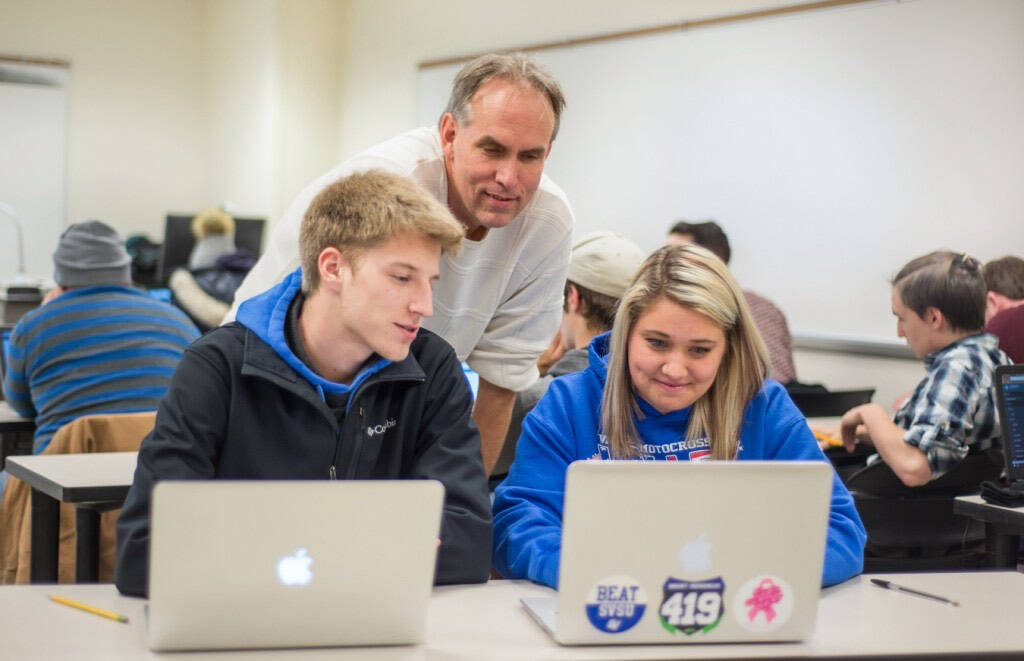 Students and instructor working on computers